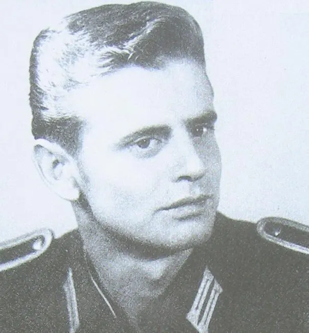 Black-and-white portrait of a young man in a uniform jacket with collar tabs