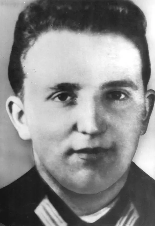 Black-and-white head-and-shoulders photograph of a young man with short dark hair in a uniform collar