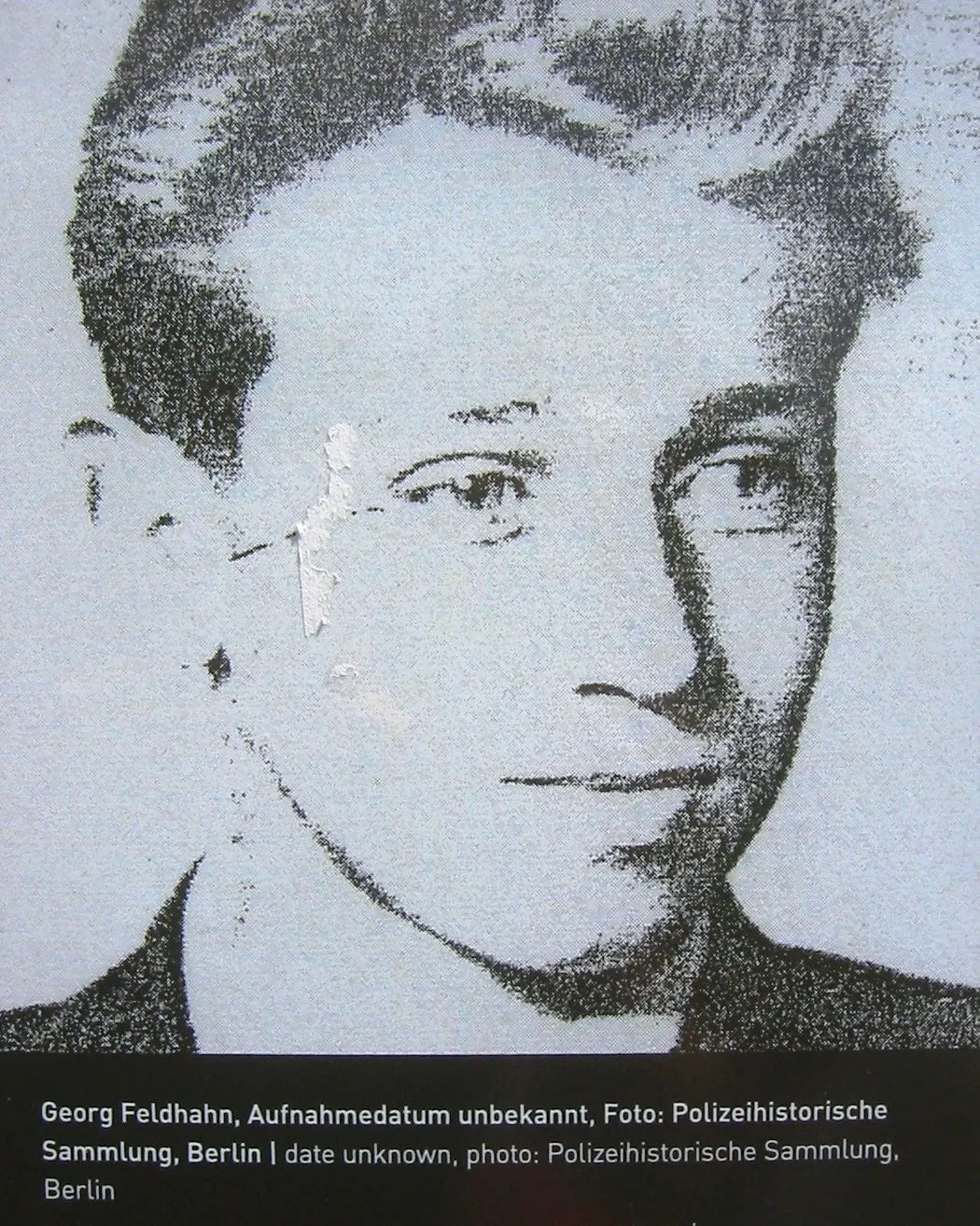 Black-and-white halftone portrait of a young man with swept hair, with a caption below crediting the Polizeihistorische Sammlung