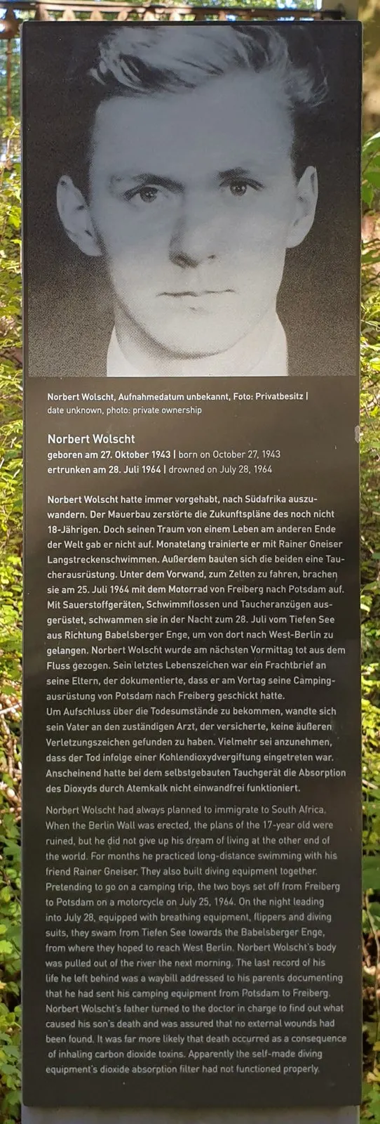 Dark panel with a large black-and-white photograph of a young man, above a German and English text headed 'Norbert Wolscht'