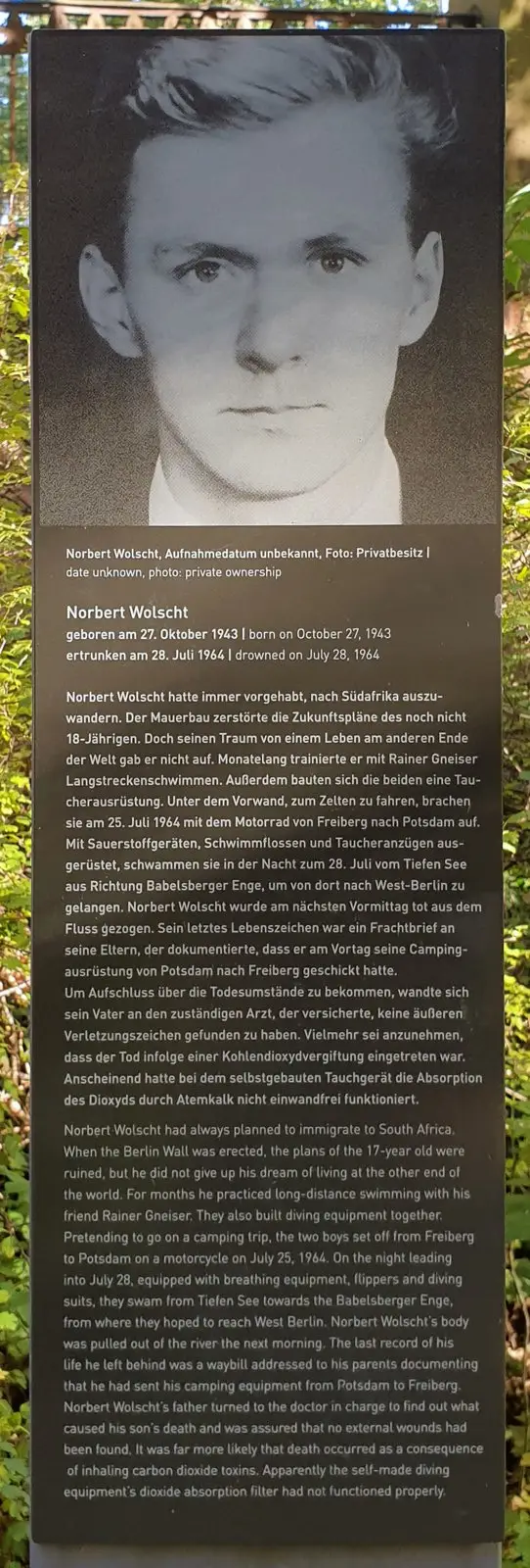 Dark panel with a large black-and-white photograph of a young man, above a German and English text headed 'Norbert Wolscht'
