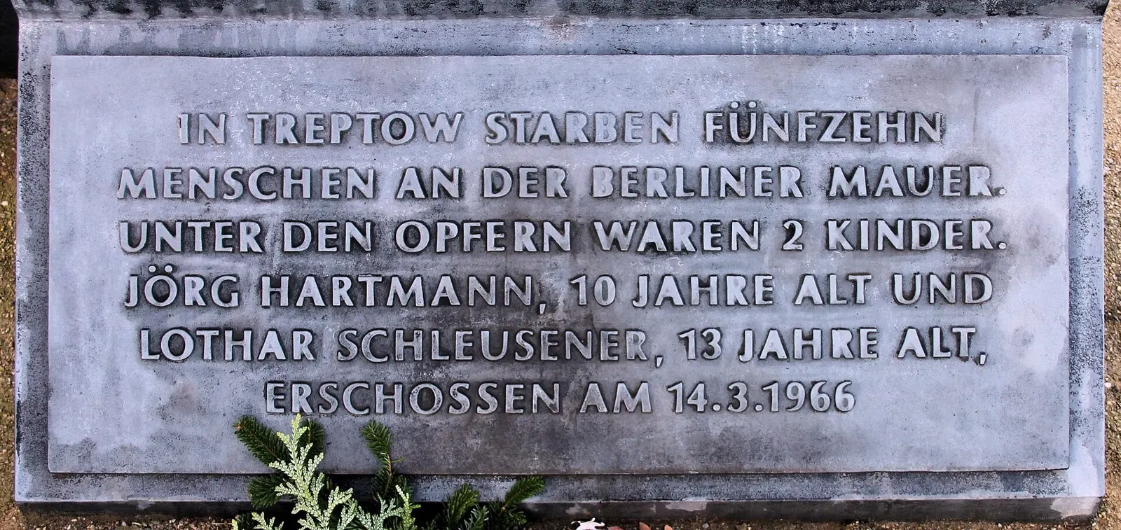 Grey stone plaque with capital letters naming Jörg Hartmann and Lothar Schleusener