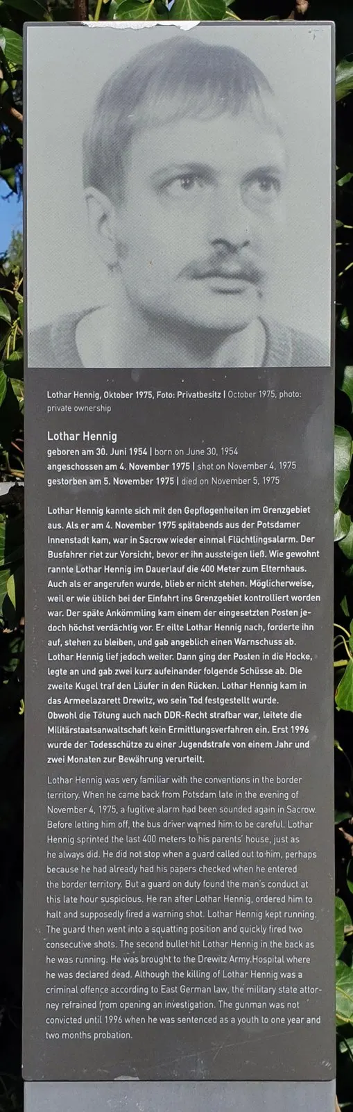 Panel topped by a black-and-white portrait of a man with a moustache, followed by German and English text